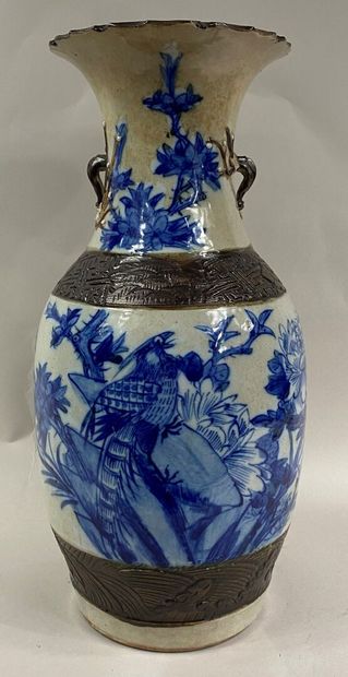  CHINA, NANKIN 
Blue enamelled stoneware baluster vase on a cream background decorated...