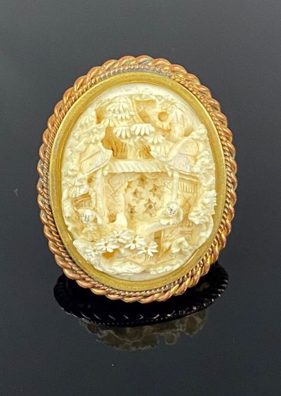  CHINA 
Marine ivory cameo brooch carved with a landscape in relief of pine trees,...