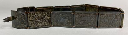  CHINA, 20th century 
Set of twelve shaded green hardstone plaques forming a belt....