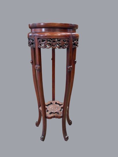  CHINA 
Round quadripod pedestal table in carved wood. Inlaid grey marble top. The...