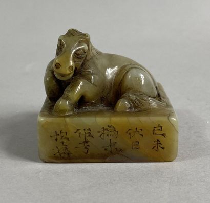  CHINA, 20th century 
Carved hard stone seal, square section, with the effigy of...