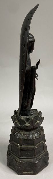  JAPAN 
Bronze subject with brown patina representing Buddha standing on a base with...