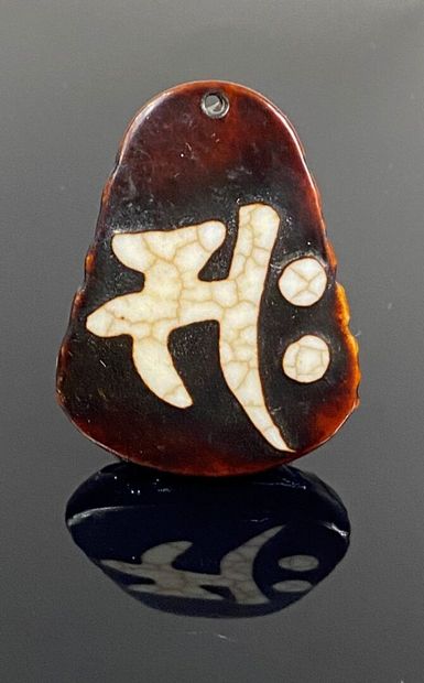  CHINA 
Brown and cream agate pendant carved with a demon. 
Reminiscent of the work...