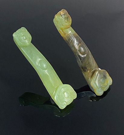  CHINA, 20th century 
Set of two bowenite and green hardstone ruyi scepters. The...