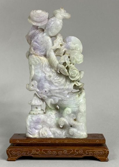  CHINA - 20th century 
Lavender and celadon jadeite group representing an immortal...