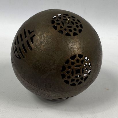  CHINE, XXe siècle 
Sphère ajourée en bronze à patine brune, ouvrant en son centre...