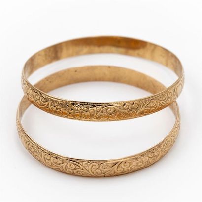 null Deux bracelets joncs rigides en or jaune 18 K (750), ciselés d'arabesques et...