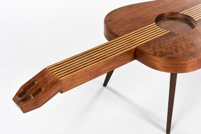 null WORK 1960

Coffee table with a tapered base and a guitar-shaped inlaid wooden...