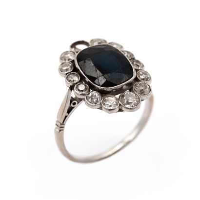 null Platinum daisy ring set with an Australian sapphire. Surrounded by old cut diamonds....