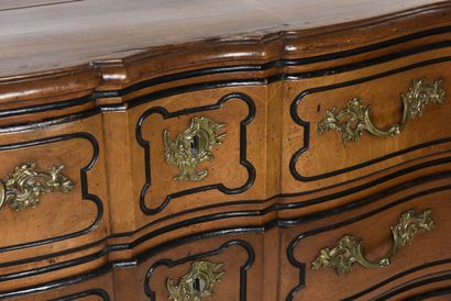 null Chest of drawers in light walnut with a curved front underlined by blackened...