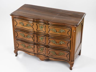 null Chest of drawers in light walnut with a curved front underlined by blackened...