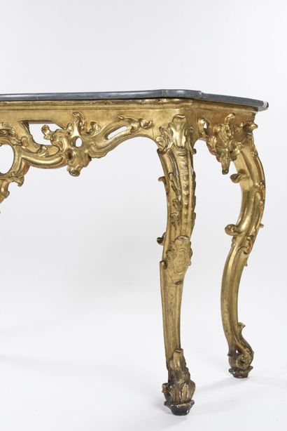 null Gilded wood console carved with large foliage scrolls, openwork crosspiece centered...