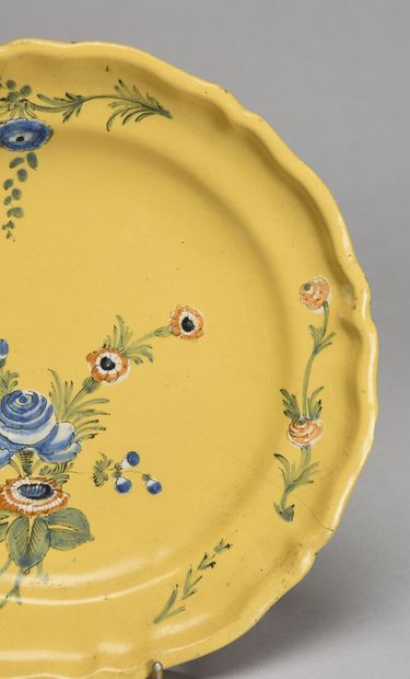 null MOUSTIERS Earthenware plate with scalloped wing decorated with a bouquet of...