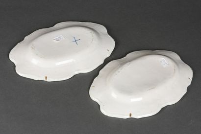 null LYON, two earthenware dishes with blue monochrome decoration of magots sitting...