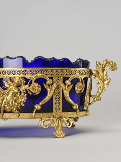 null Blue glass bowl with scalloped edge and gilded brass mount decorated with cherubs...