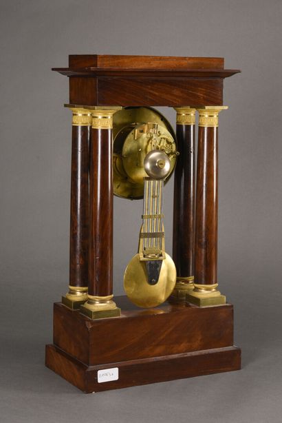 null Portico clock in mahogany, silvered steel dial with Roman numerals, the base...