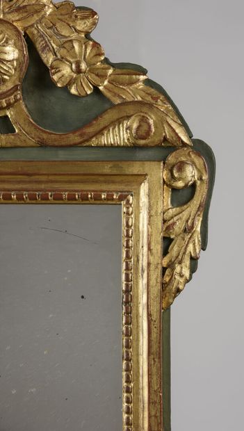 null Gilded wood pediment mirror carved with flowers held by a rose window.

Louis...