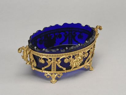 null Blue glass bowl with scalloped edge and gilded brass mount decorated with cherubs...