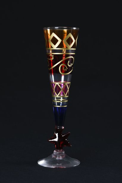 null Suite of eleven colored glass flutes decorated with golden geometric friezes,...