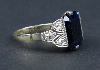 null 18k (750) white gold and platinum ring, set with a large step-cut sapphire enhanced...