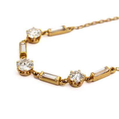 null Necklace in 18 K (750) yellow gold, cut with three brilliant-cut diamonds alternated...