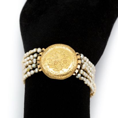 null Bracelet composed of five rows of baroque pearls, with a watch-case motif in...