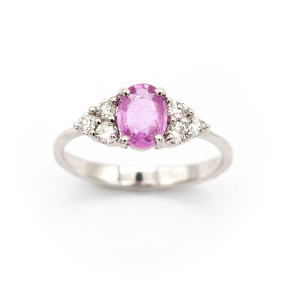 null 18K white gold ring set with an oval-cut pink sapphire weighing approximately...