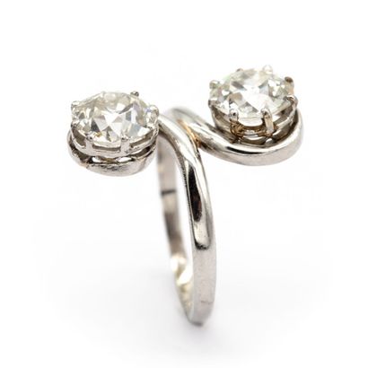 null A platinum "you and me" ring set with two old-cut diamonds, each weighing approximately...