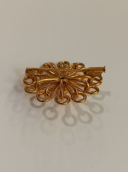 null Brooch in 18 K (750) yellow gold featuring a stylized sun. 

Weight 10,50 
...