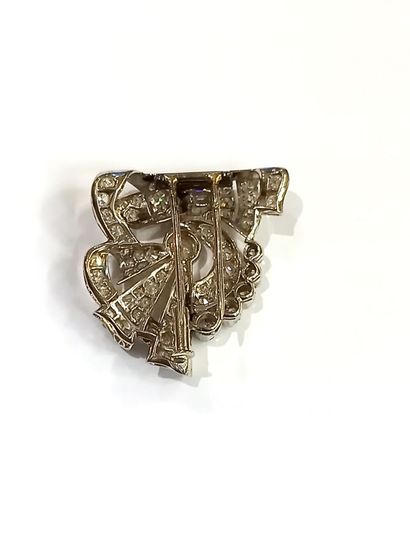 null Lapel clip in 18K (750) white gold, scrolling and volutes of baguette and old-cut...