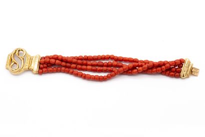 null Bracelet composed of four rows of coral beads, featuring a snake. 18K yellow...