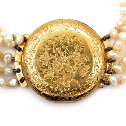 null Bracelet composed of five rows of baroque pearls, with a watch-case motif in...