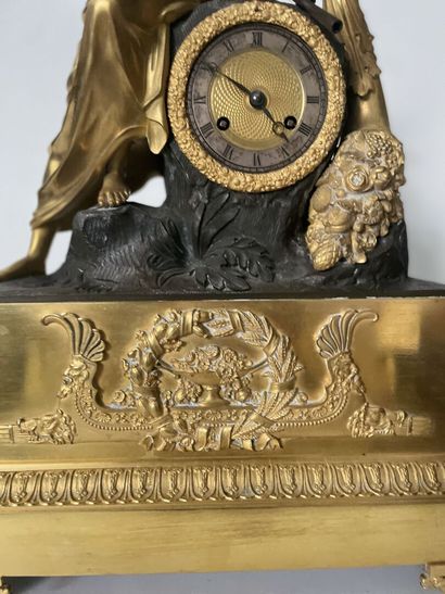 null Clock in chased bronze, patinated and gilded, representing Hope holding an anchor,...