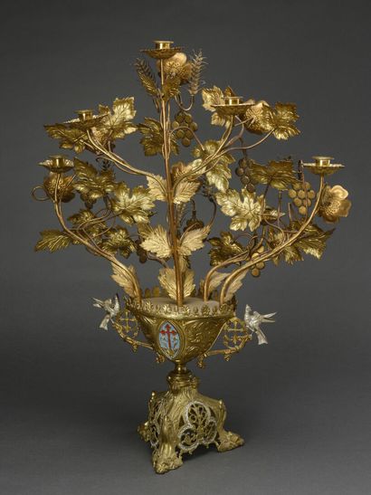 null Altar candelabra formed by a vase, centered by an enamelled shield, surmounted...