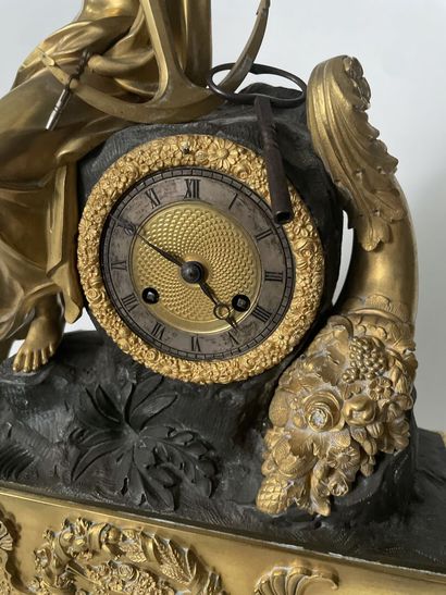 null Clock in chased bronze, patinated and gilded, representing Hope holding an anchor,...