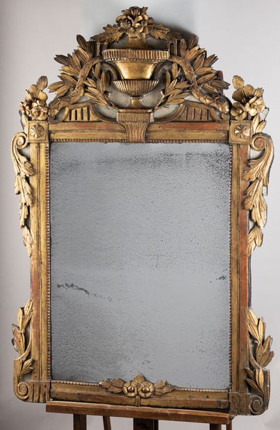 null Mirror in lacquered and gilded wood with relief decoration of a vase in the...