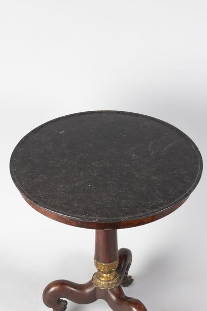 null Mahogany and mahogany veneer tripod pedestal table with a baluster shaft resting...