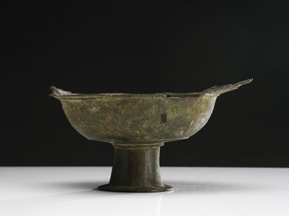 null Lot including a cup on pedestal with a protruding lip, bronze with important...