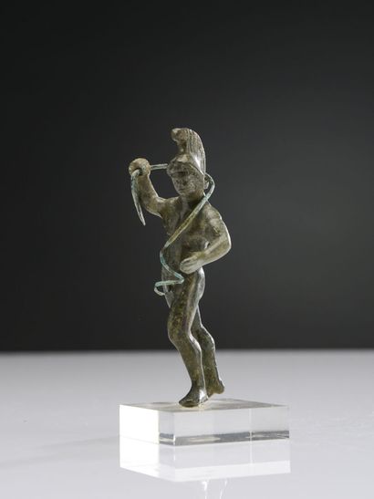 null Statuette of naked Mars, helmeted, raising his right arm. He is holding a snake...