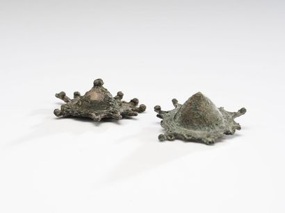 null Pair of truncated cone-shaped fibulas with star-shaped decoration.
Bronze with...