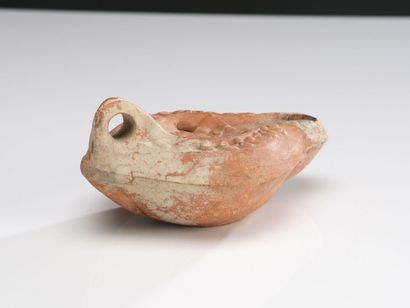 null Oil lamp with channel spout decorated with a medallion showing a male bust holding...