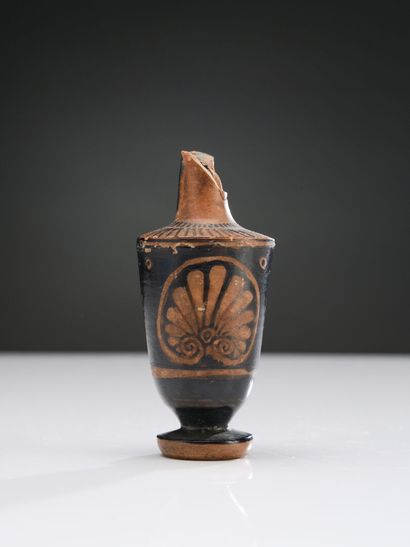 null Miniature lekythos with red figures decorated with a palmette.
Orange terracotta...