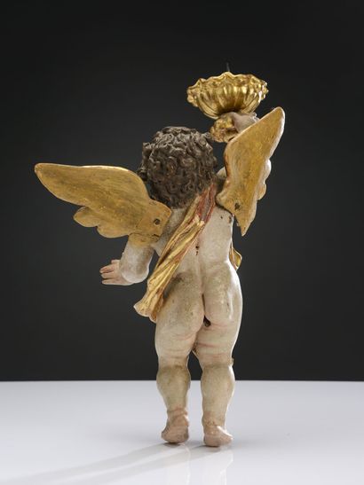 null Pair of cherubs in polychrome and gilded wood forming a candle stick.
Work of...