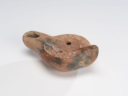 null Oil lamp with channel spout, decorated with a galloping horse passing to the...