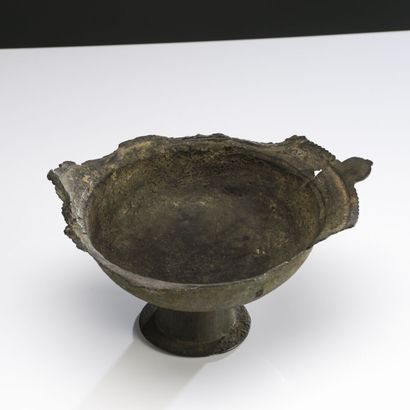 null Lot including a cup on pedestal with a protruding lip, bronze with important...