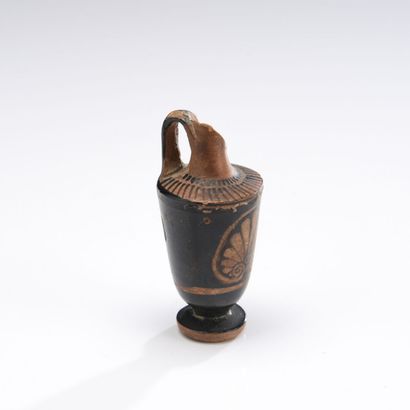 null Miniature lekythos with red figures decorated with a palmette.
Orange terracotta...
