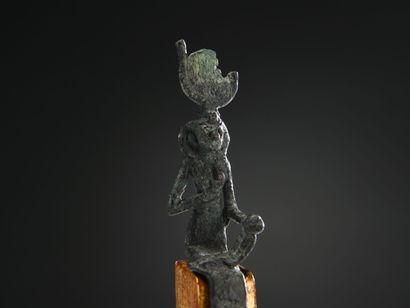 null Statuette of Isis lactans, representing the goddess Isis seated, carrying her...