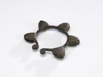 null Open bracelet finished by two volutes and decorated with five bells in the form...