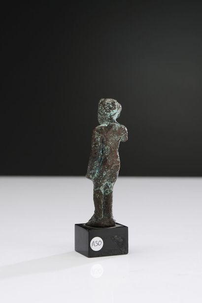 null Statuette of Harpocrates-Horus as a child, depicted naked, with his arms along...