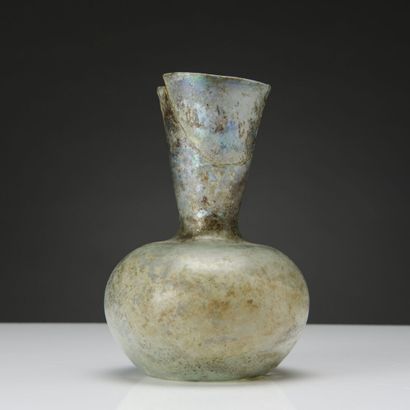 null Jug with globular body and truncated conical neck.
Iridescent bluish glass....